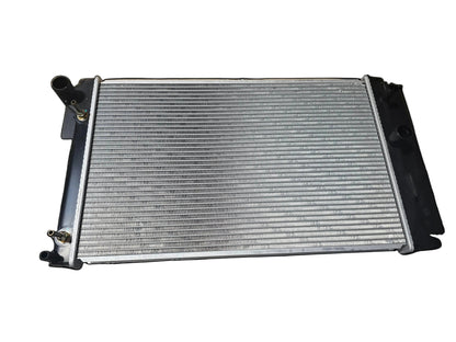 KRA20422 Car radiator on a metal surface with cardboard boxes in the background