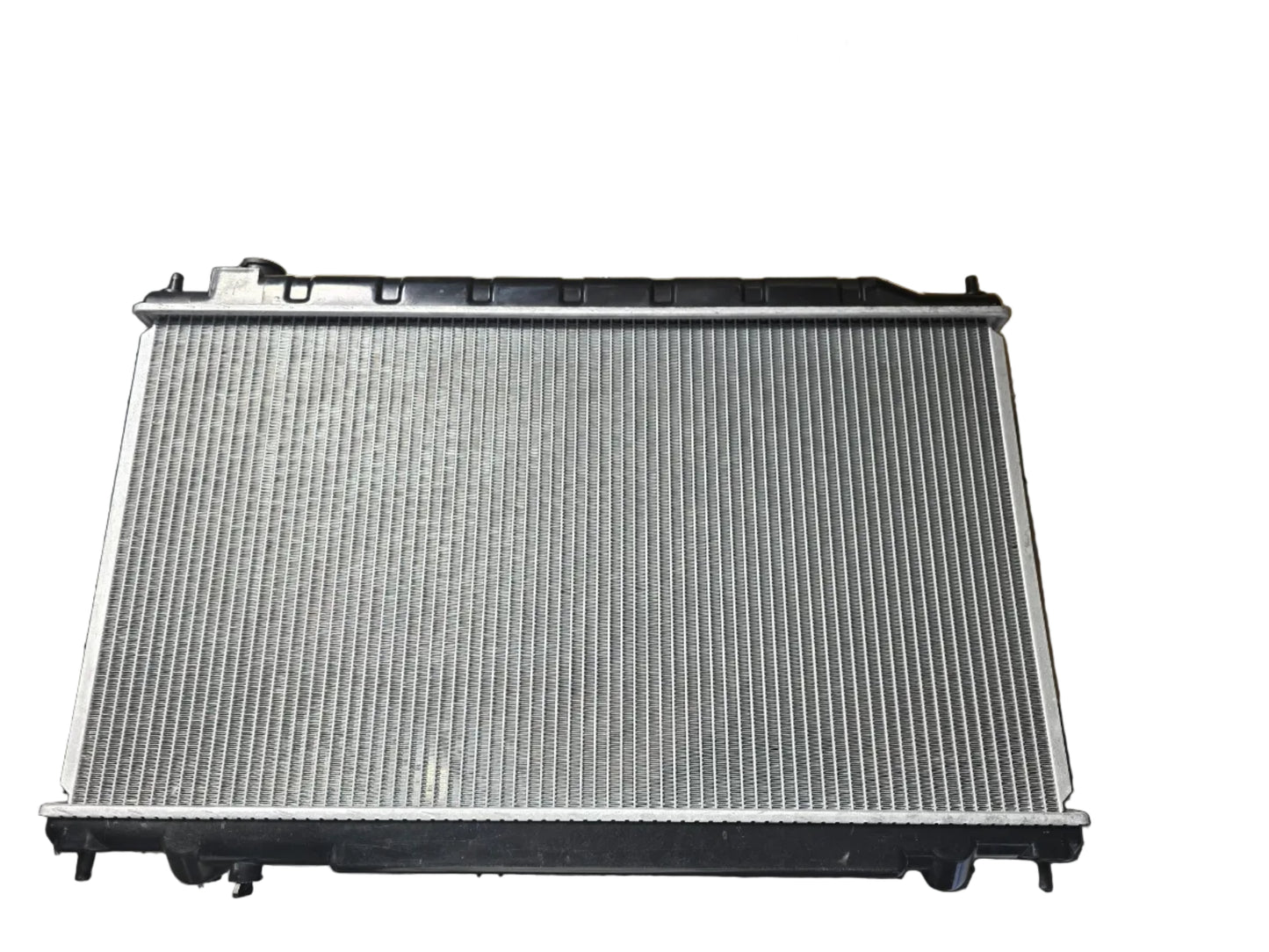 Kra10192 Car radiator on a metal surface with cardboard boxes in the background