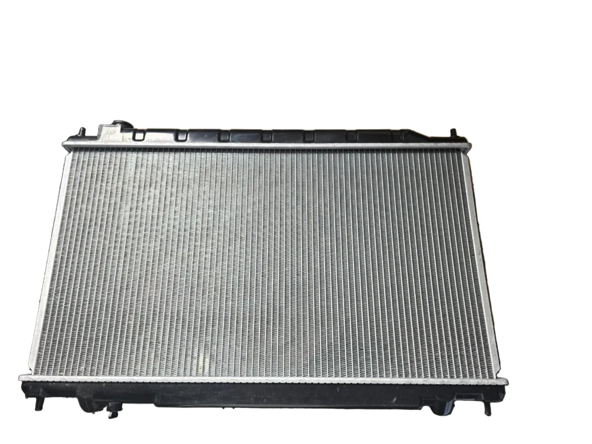 Kra10192 Car radiator on a metal surface with cardboard boxes in the background