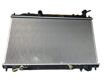 Kra10192 Car radiator on a black surface with cardboard box in the background